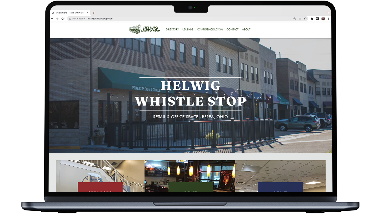 Updated Helwig Whistle Stop website on laptop screen.