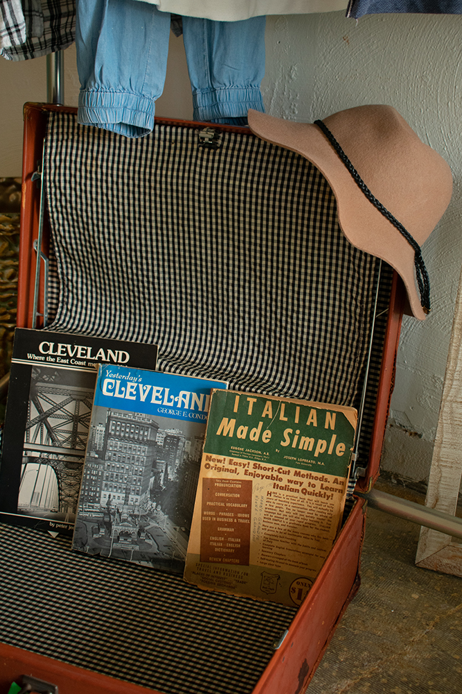 Clevelnd history books in antique suitcase with felt hat on top. Product photography for Relic Vintage.