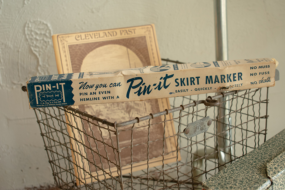 Pin-It vintage skirt maker on wire cart with Cleveland Past brochure. Product photography for Relic Vintage.