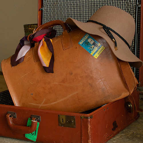 Suitcase with carry-on bag, hat, and scarf in it. Product photography for Relic Vintage.