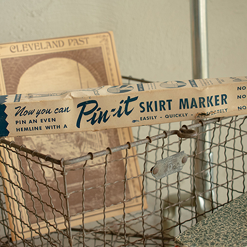 Pin-It vintage skirt maker on wire cart with Cleveland Past brochure. Product photography for Relic Vintage.