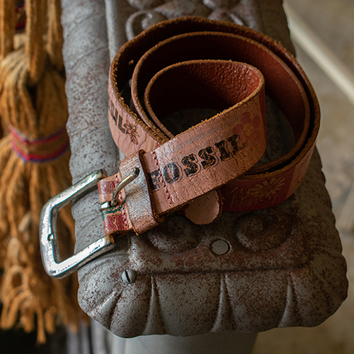 Fossil belt resting on decorative ledge. Product photography for Relic Vintage.