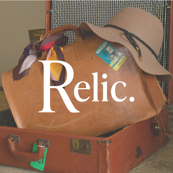 Relic logo over image of books in suitcase with hat.
